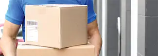 A person carrying shipping boxes